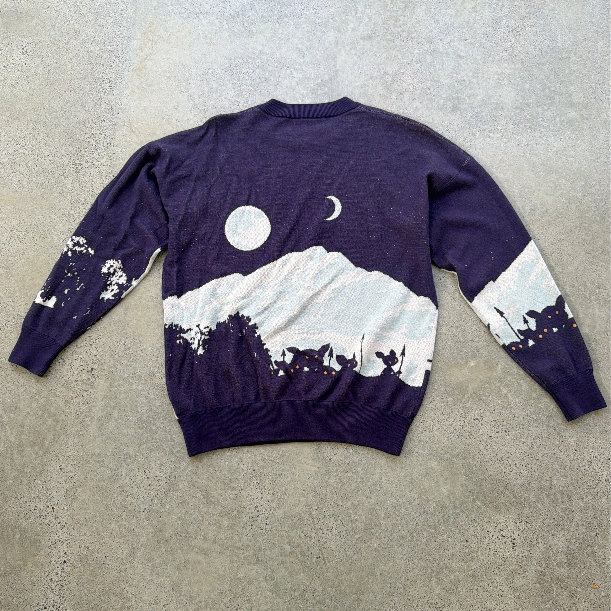 Navy blue knitted sweater with The Wandering Inn logo and artwork