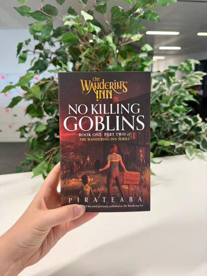 No Killing Goblins paperback, Book One Part Two of The Wandering Inn series by pirateaba, front cover held up in hand