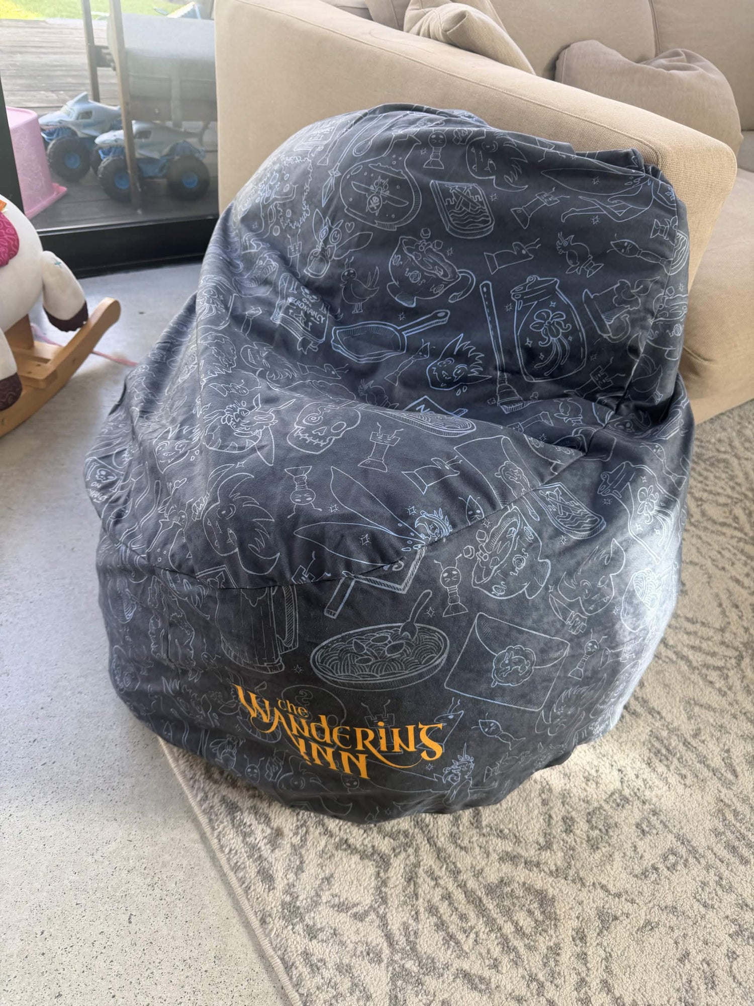 Bean bag chair with 'The Wandering Inn' design on a carpeted floor.