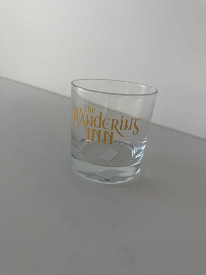 The Wandering Inn logo rocks glass with gold wordmark and weighted base